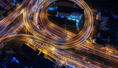 Image of a highway with many exits, covered in lights. The highway conveys a message of having a road to many places that goes with this poem entitles "An Escape"