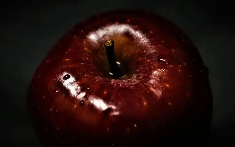 An image of a red apple on a black background to subtle convey the darkness and passion of intense pain