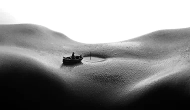 An abstract image of a womans stomach with her navel filled with water and someone in a boat near her belly button, as though on a lake. The image conveys the sensual nature of the poem titled "The visit"