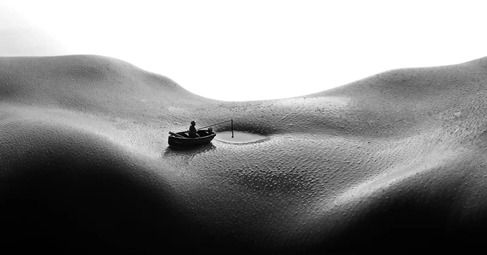 An abstract image of a womans stomach with her navel filled with water and someone in a boat near her belly button, as though on a lake. The image conveys the sensual nature of the poem titled "The visit"