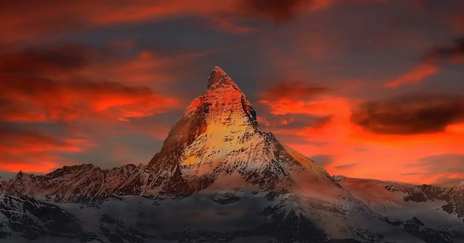Scenic view of a mountain against a red sky with orange clouds, evoking the essence of a poem Born to Live.