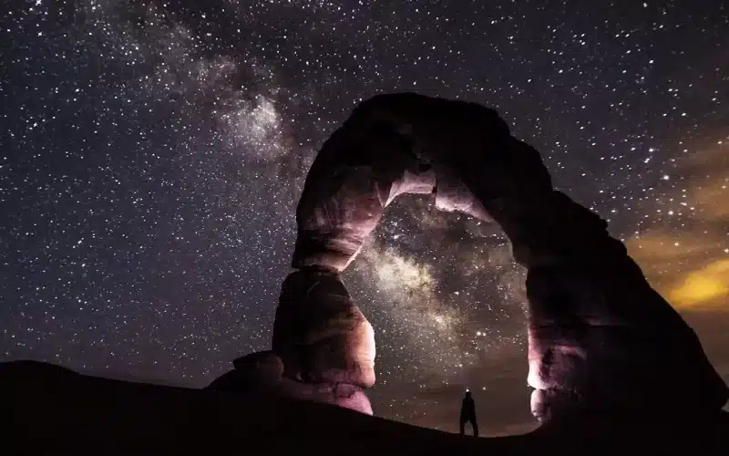 The breathtaking Milky Way shining above Delicate Arch at night, creating a mesmerizing celestial spectacle.