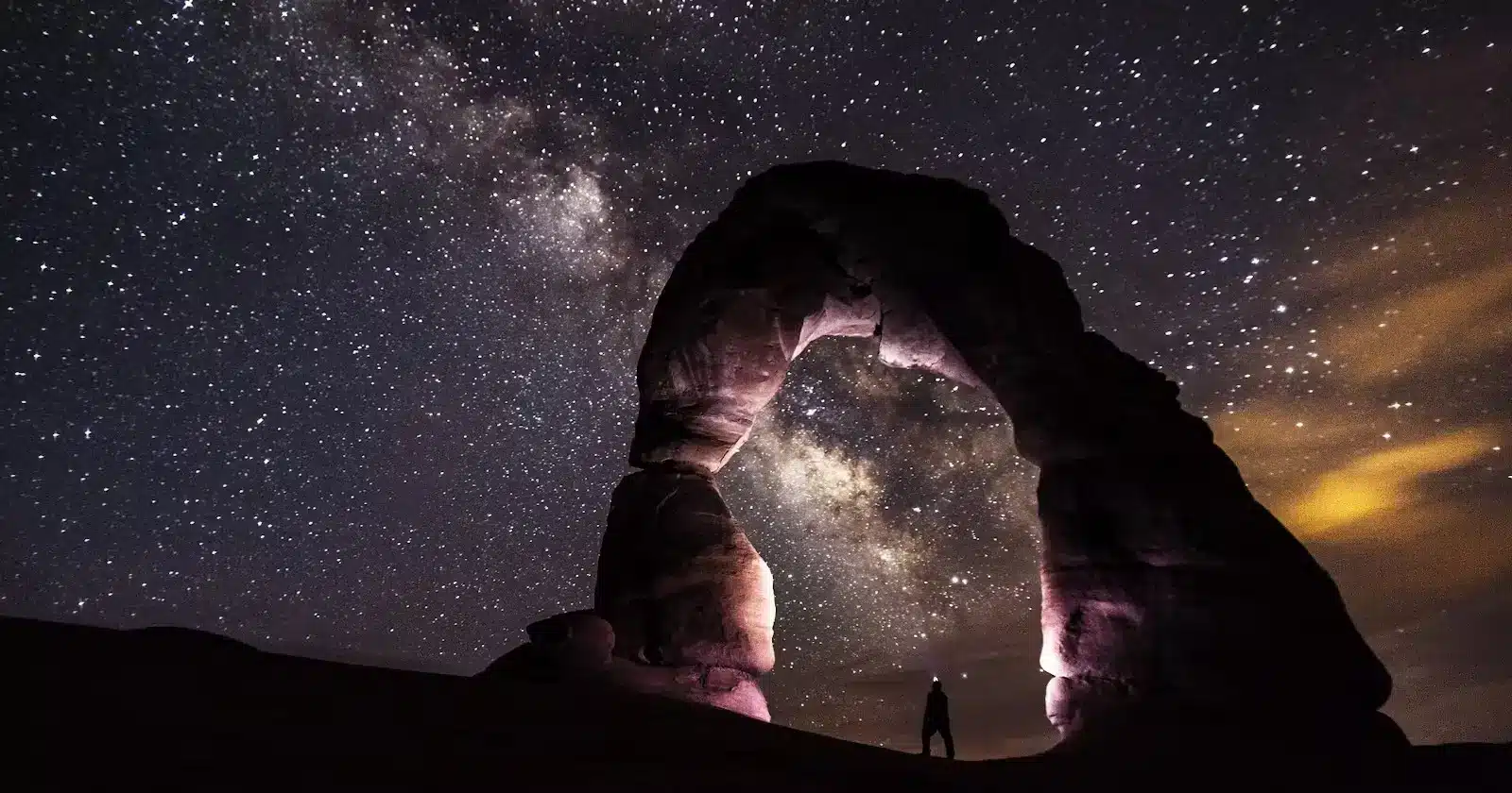 The breathtaking Milky Way shining above Delicate Arch at night, creating a mesmerizing celestial spectacle.