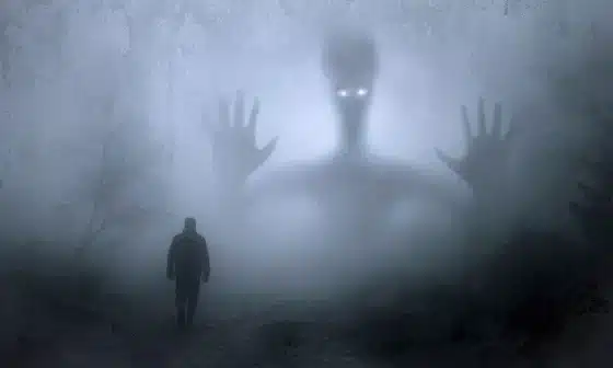 A man strolling through fog with a giant hand looming nearby.It showcase confronting the duality of the inner beast, pondering its nature and the choice between destruction and unity.
