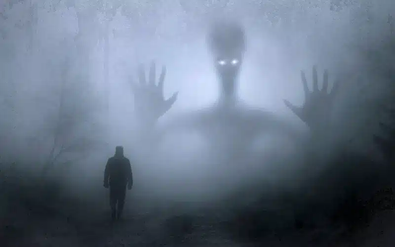 A man strolling through fog with a giant hand looming nearby.It showcase confronting the duality of the inner beast, pondering its nature and the choice between destruction and unity.