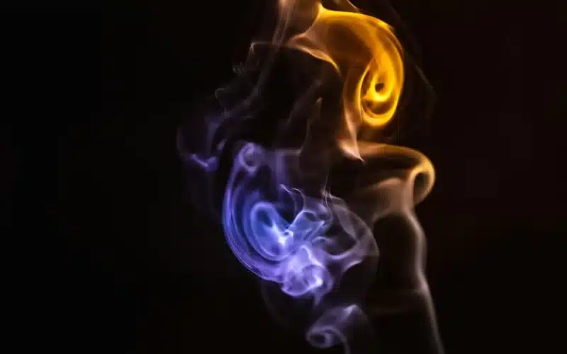 A captivating blend of colorful smoke dances on a black canvas, capturing the essence of a shared moment and boundless connection.