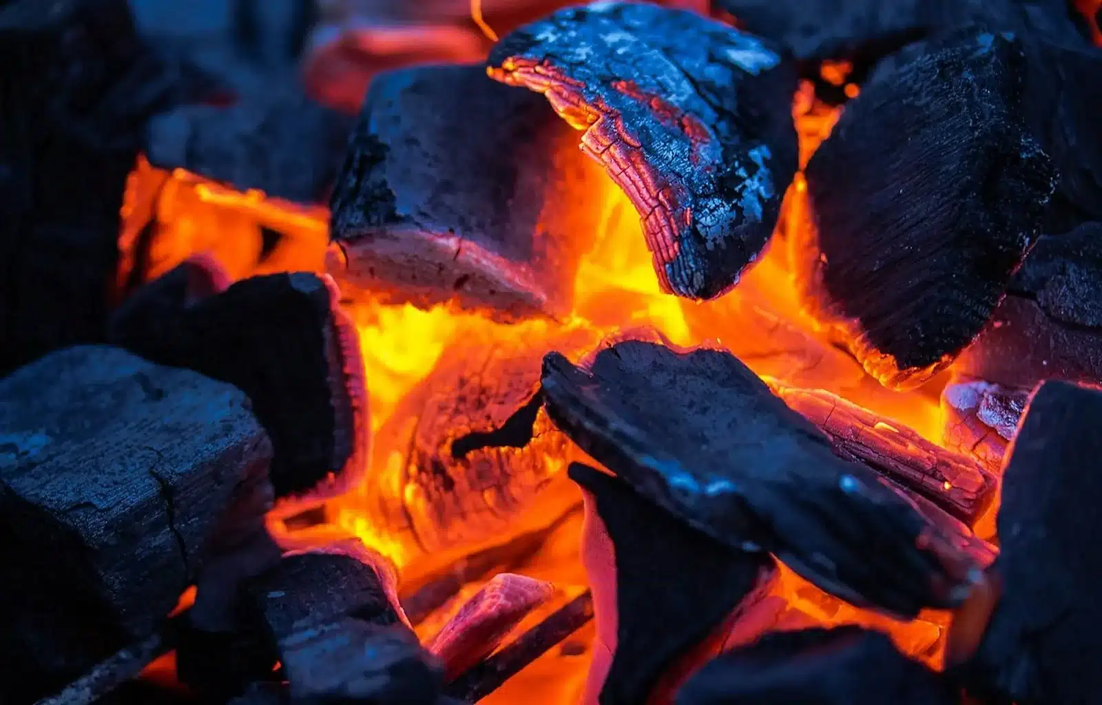 Image of Charcoal and wood burning in a fire, symbolizing determination and faith to overcome doubts and fears.