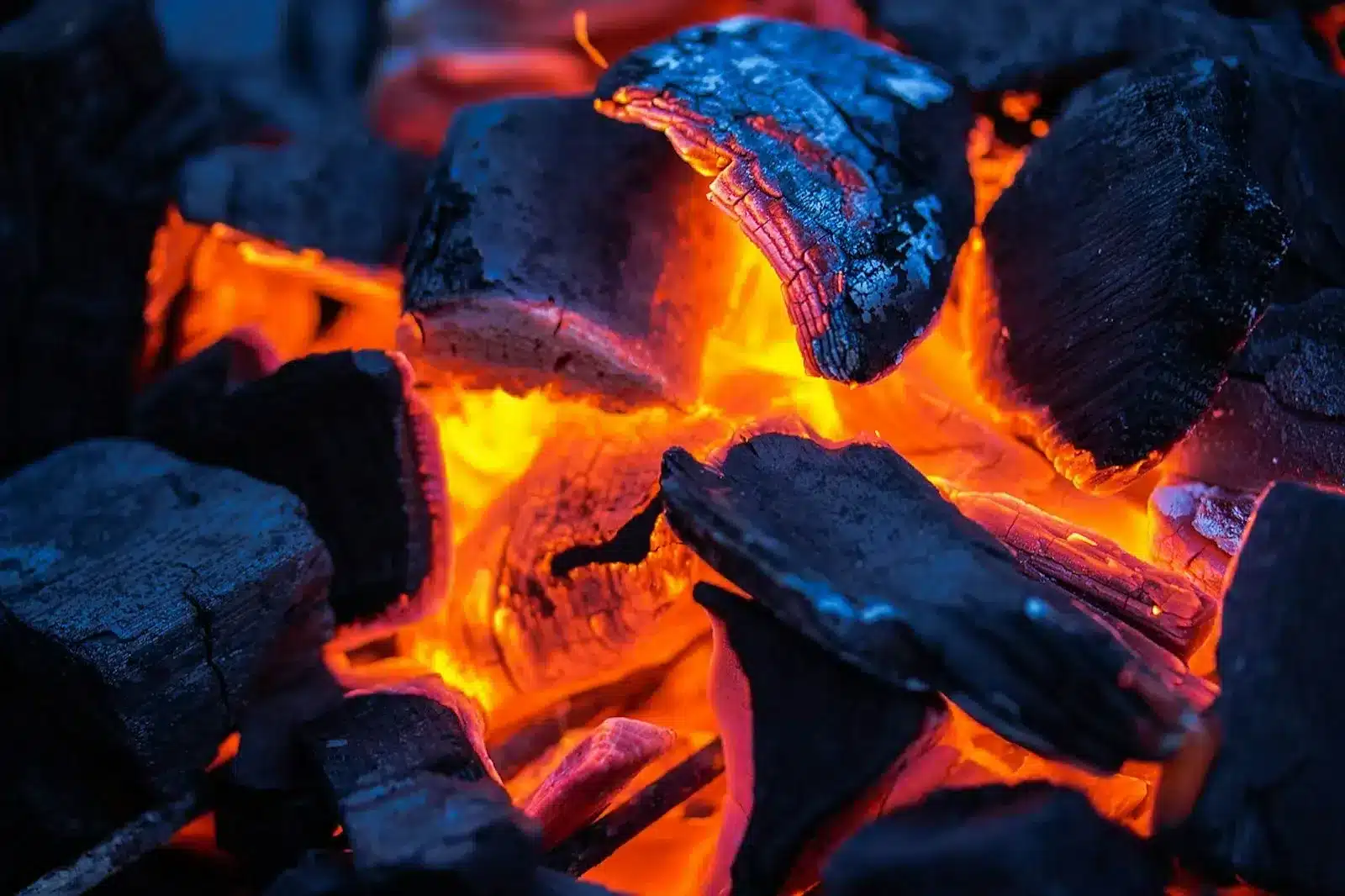 Image of Charcoal and wood burning in a fire, symbolizing determination and faith to overcome doubts and fears.