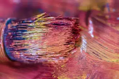 A close-up of a colorful paintbrush, symbolizing the interplay between confronting inner demons and navigating the world's horrors.