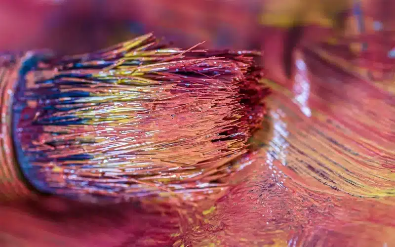 A close-up of a colorful paintbrush, symbolizing the interplay between confronting inner demons and navigating the world's horrors.