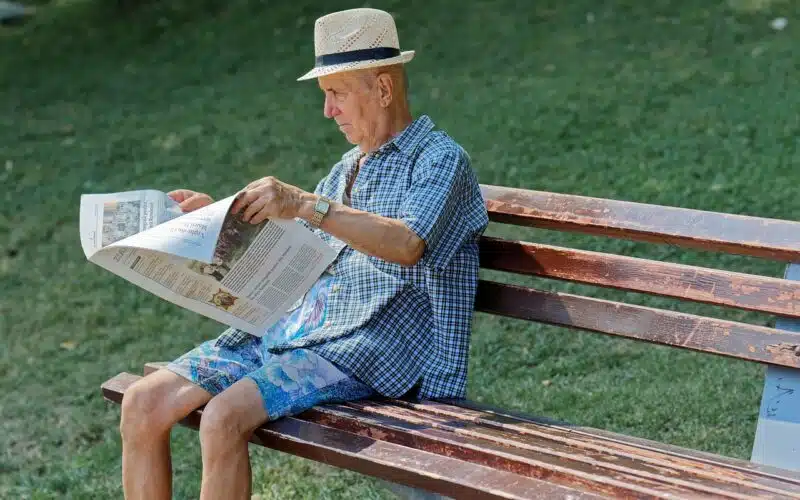 Man reading news paper for the latest news. Read about the Scandal in Bogotá