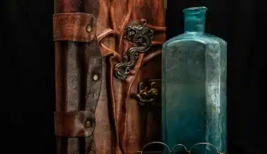 Image of abook, bottle, and glasses on a table.To go along with the story Severed Entanglement: Ritual of Eternal Temptation The Adventures of Griffin and Karen