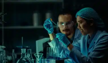 Image of Two scientists in lab coats conducting an experiment with a test tubeto go along with the “Back to the Lab: The Adventures of Griffin and Karen Exp 5