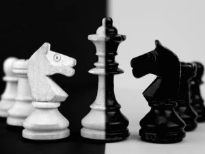 Image of a black and what chess set symbolizing the manipulation and mind games at play in Part 6 of the Bloody Tulip Short Story Series "Twisted Intentions"