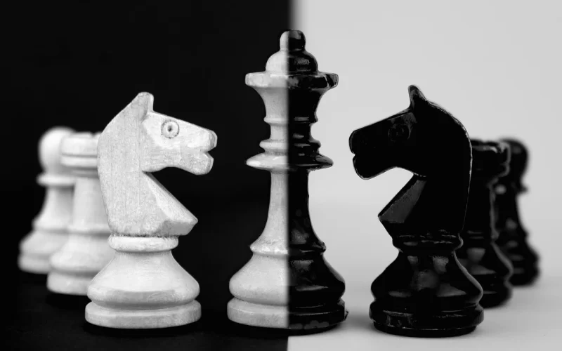 Image of a black and what chess set symbolizing the manipulation and mind games at play in Part 6 of the Bloody Tulip Short Story Series "Twisted Intentions"