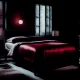 Image of a darkly light bedroom with a bed draped in red silk sheets with a red theme. The image captures the intense scene of the installment that takes place a bedroom